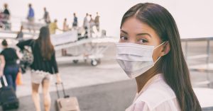 Woman With Face Mask Boards Plane
