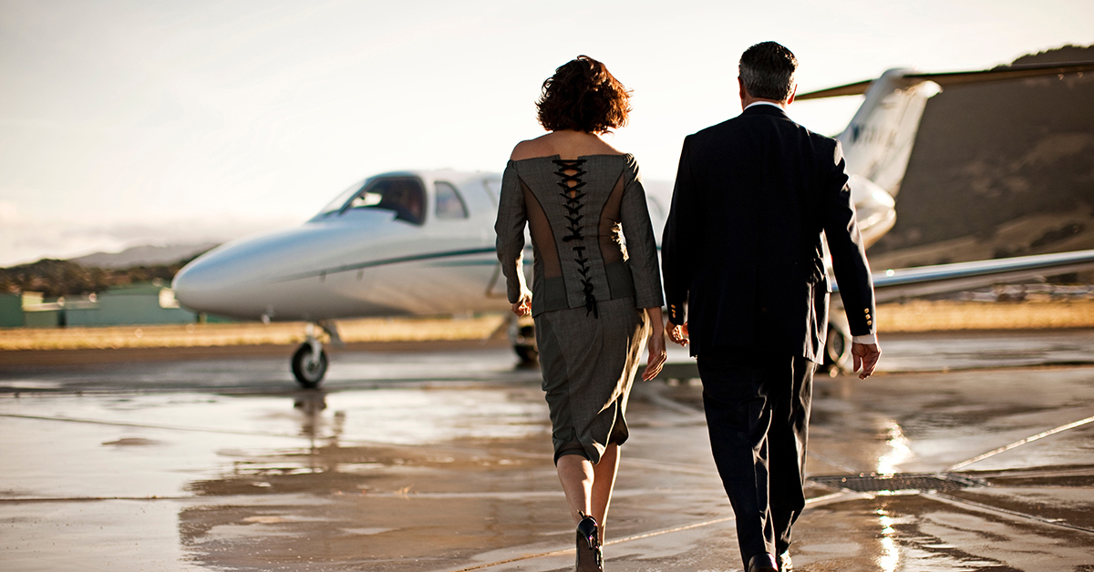 Well Dressed Man And Woman Approach Private Jet