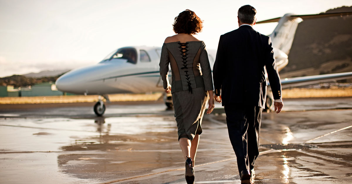 well dressed couple private jet