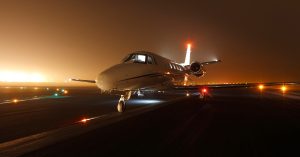 Private jet on runway at night