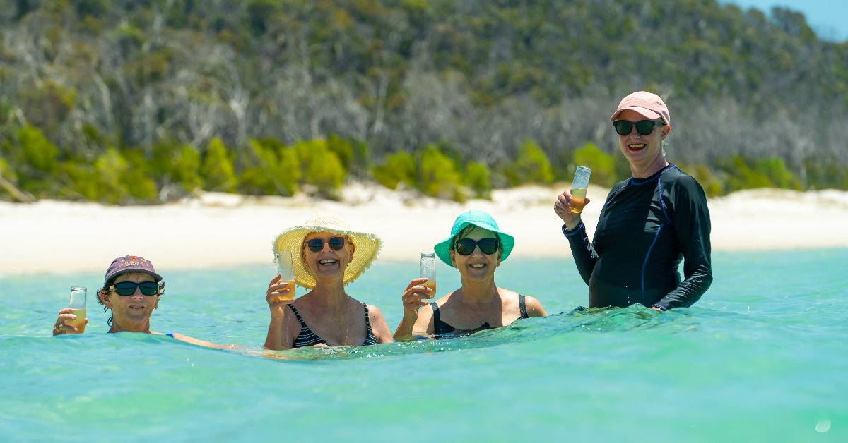 Adagold Whitsunday Wonder Jet Experience WLSQ raffle winners enjoying the clear waters of Whitehaven Beach